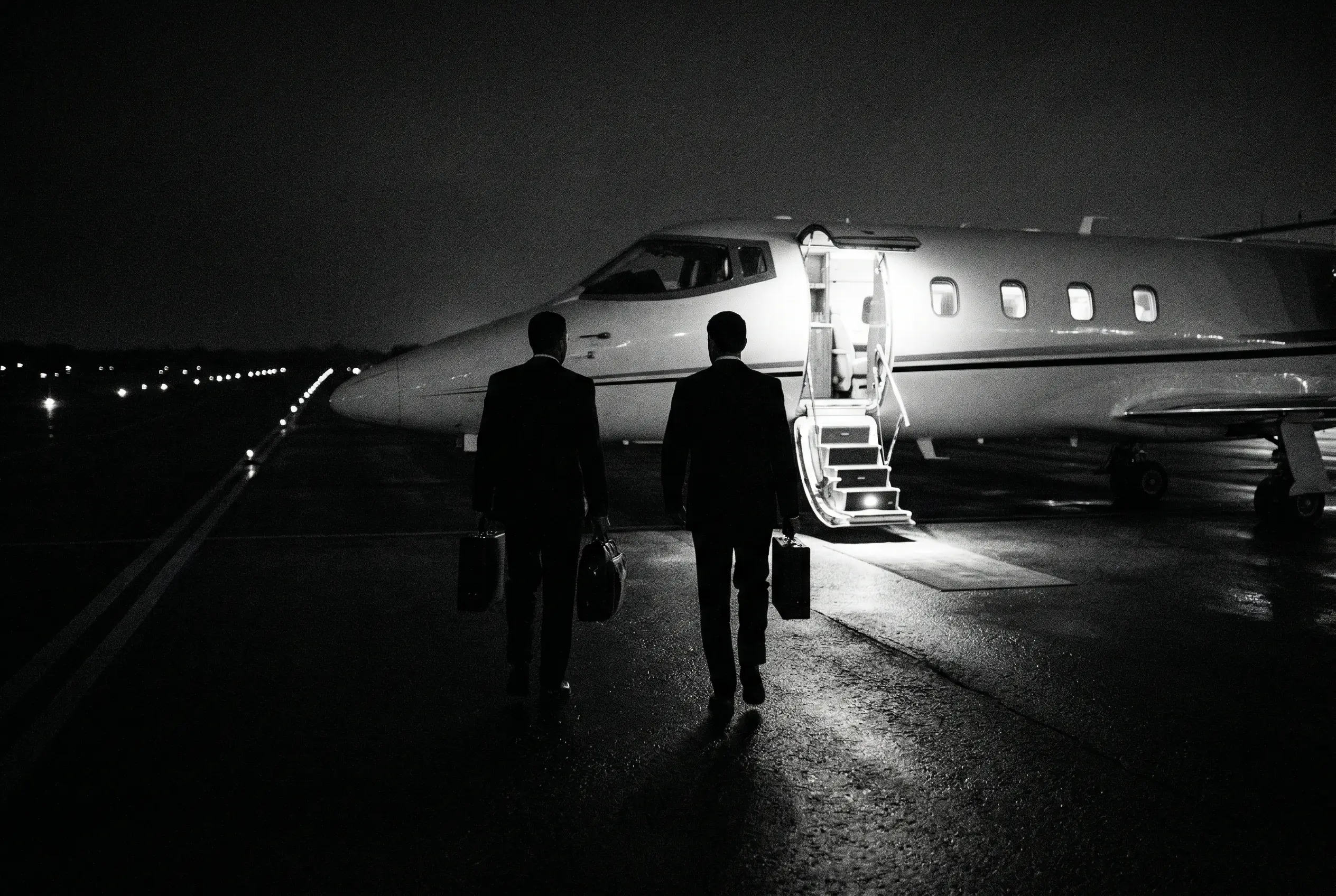 Passengers boarding a Learjet 60XR via airstair at a private FBO